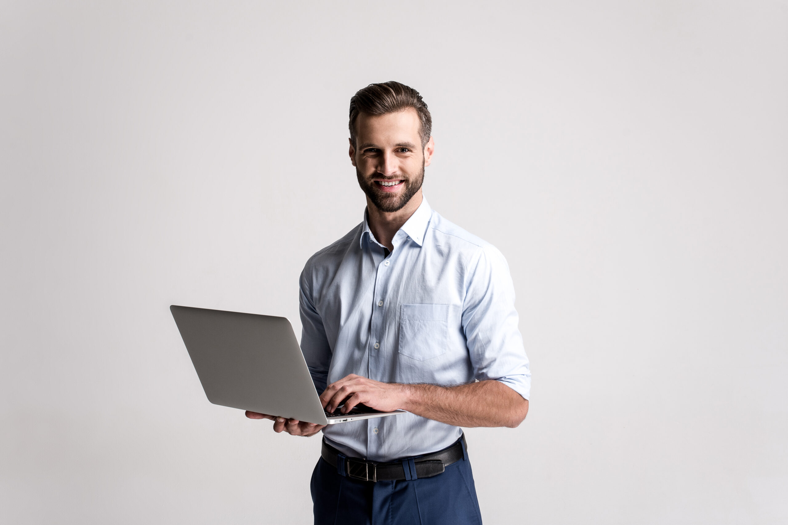 Working,With,Joy.,Handsome,Young,Man,Using,His,Laptop,And